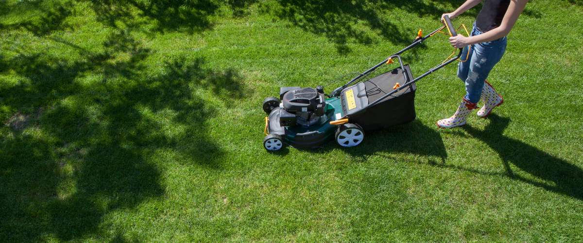 woman mowing lawn
