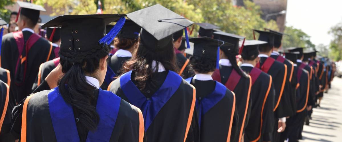 Graduates of the university ,Walking in line to get a diploma.
