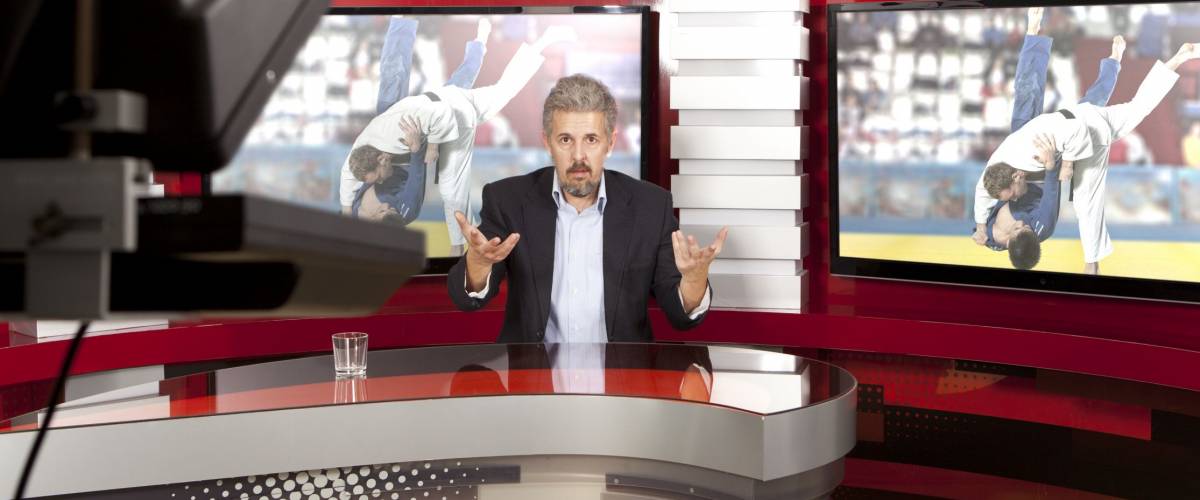 Sports News. A television anchorman at studio during live broadcasting