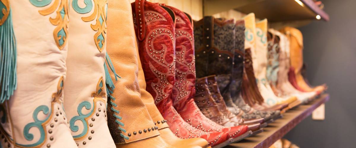 Cowboys boots on a shelf in a store, aligned
