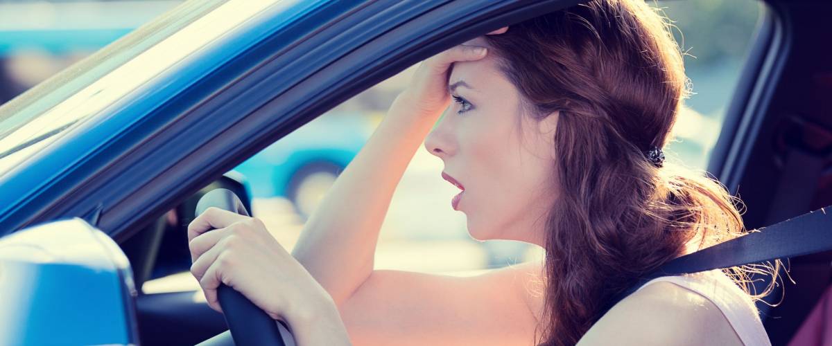 Side view window portrait displeased stressed angry pissed off woman driving car annoyed by heavy traffic