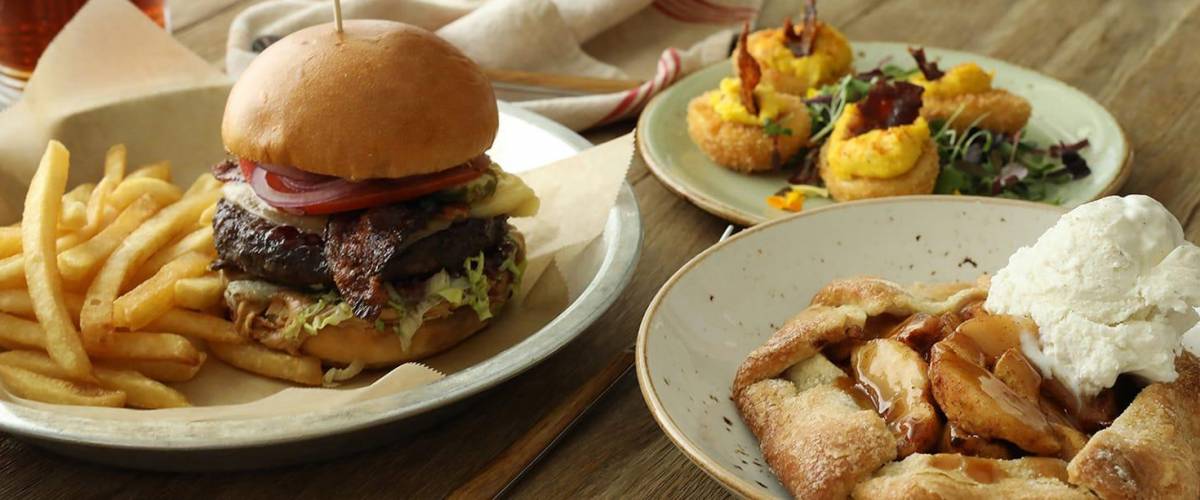 A burger, crispy deviled eggs and apple pie at a lazy dog location