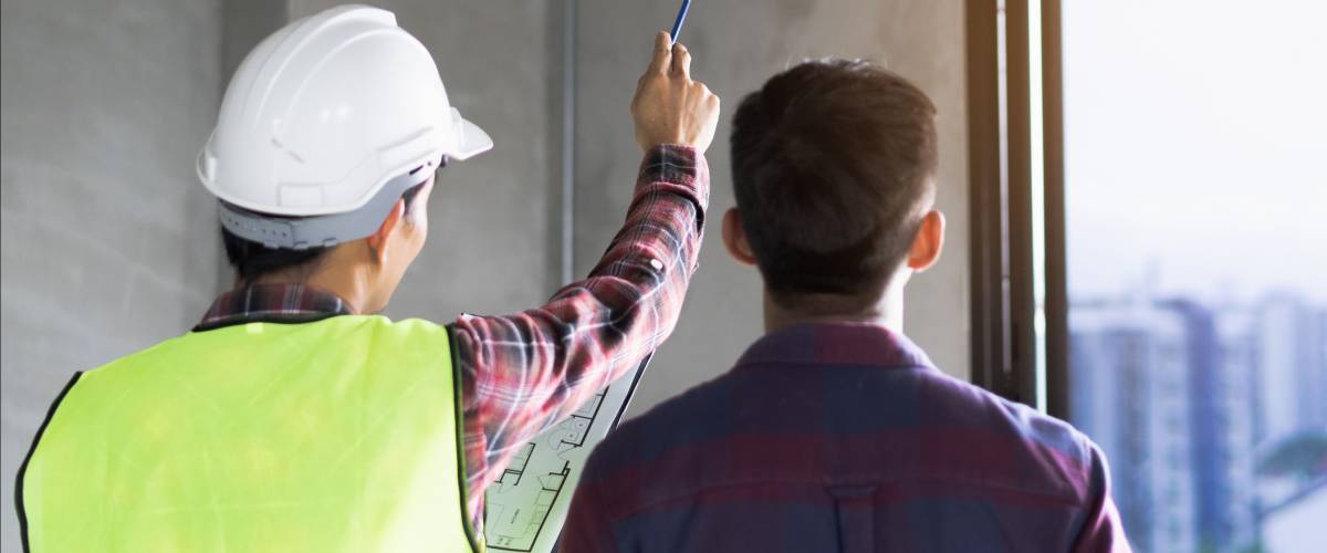 Client and Contractor discussing plan to renovation house.