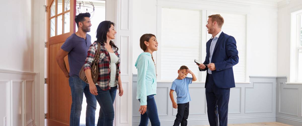 Realtor Showing Hispanic Family Around New Home