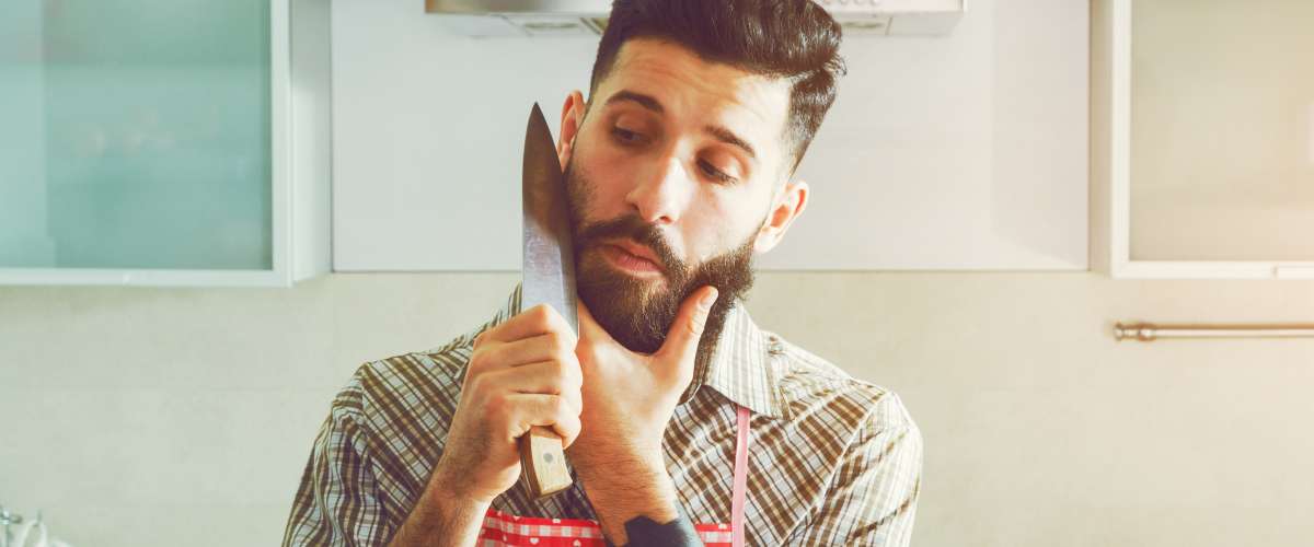 man shaving with a large kitchen knife