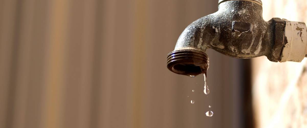 old rusty tap leaking water
