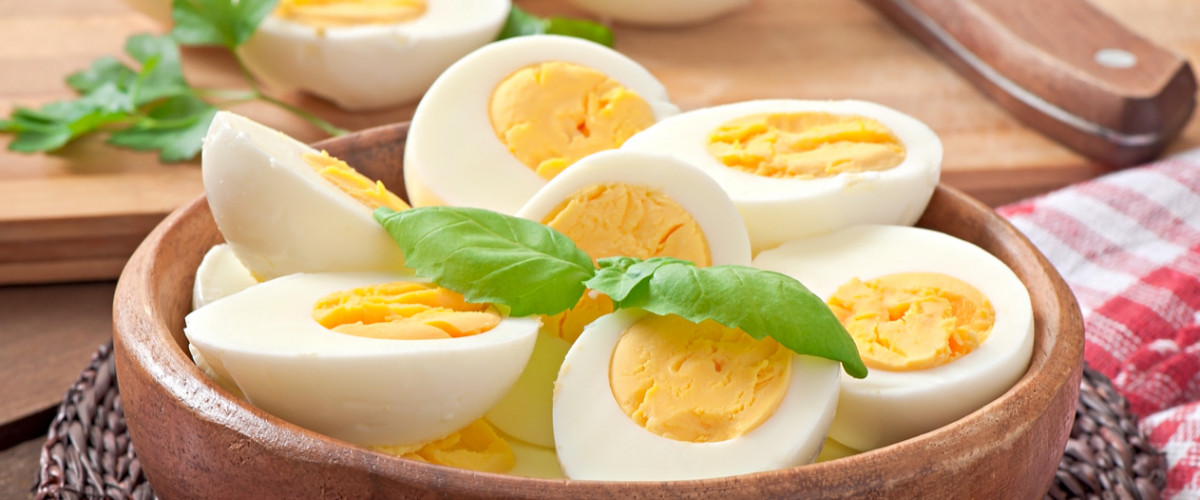 Boiled eggs in a bowl decorated with parsley leaves