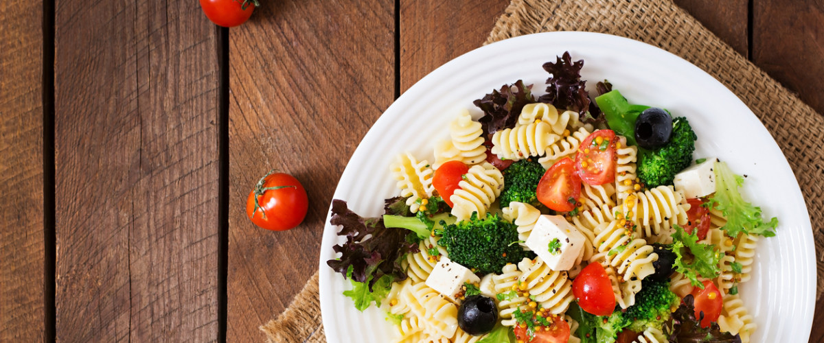 Pasta salad with tomato, broccoli, black olives, and cheese feta