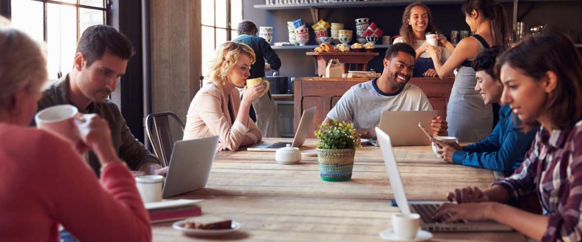 nterior Of Coffee Shop With People Using Digital Devices
