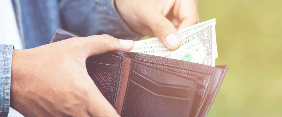 Businessman Person holding an wallet in the hands of an man take money out of pocket.