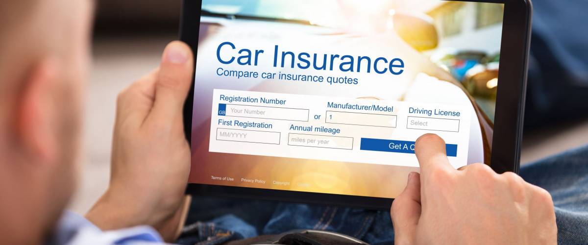 Close-up Of A Man Filling Car Insurance Form On Digital Tablet