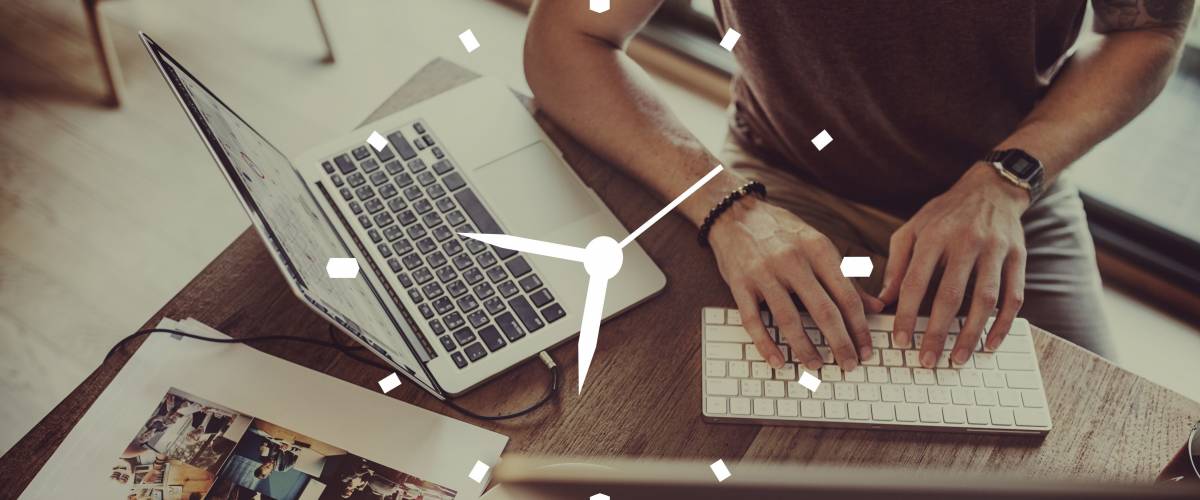Analog clock face imposed on top of a man working at his computer desk