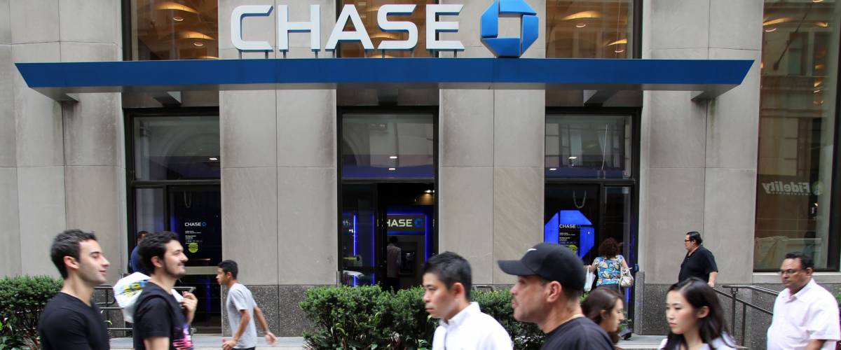 People walking by Chase Bank, owned by JPMorgan Chase & Co.