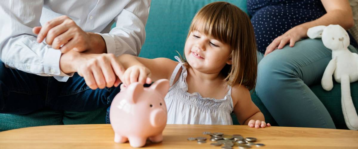 Family saving money in piggy bank