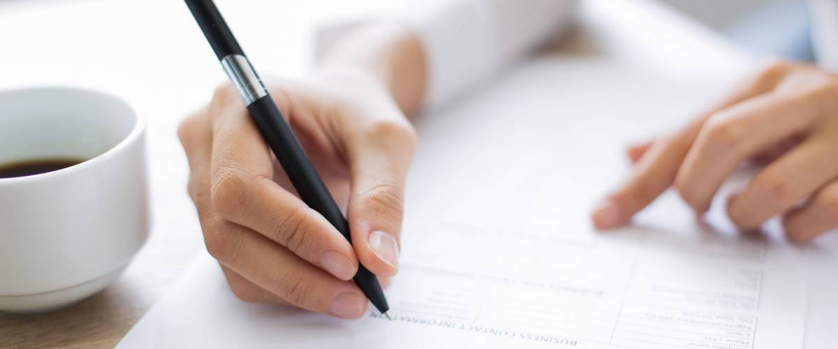 Closeup of Applicant Completing Application Form