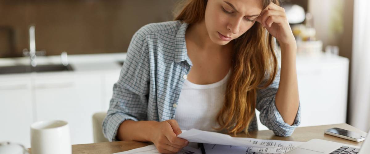 woman looking at her various bills