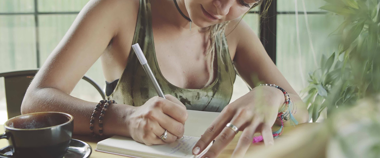 Young woman writting in her journal or diary