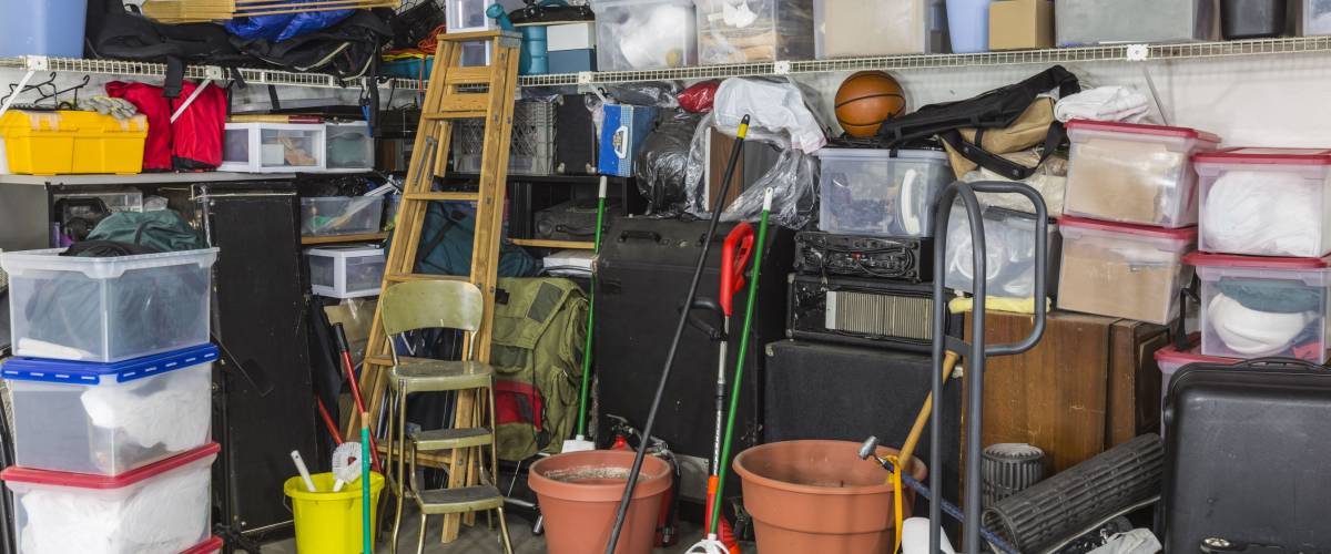 Residential garage full of junk and storage.