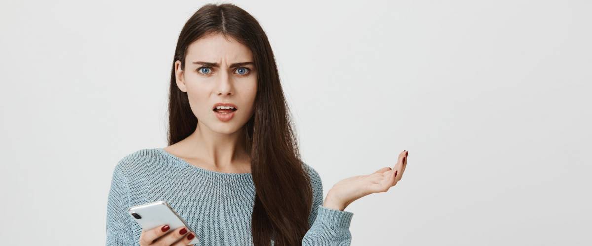 woman clueless holding up hand in disbelief