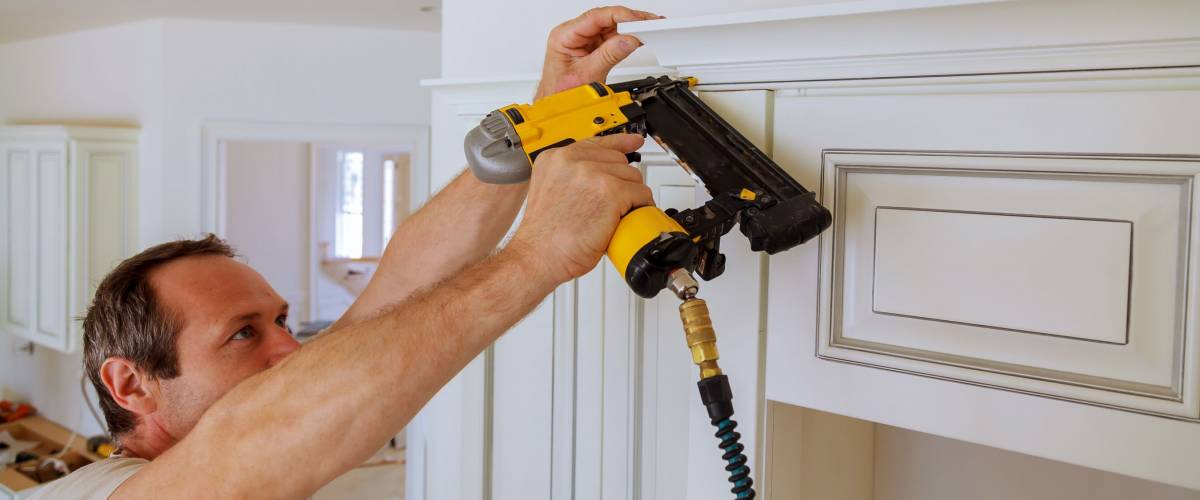 carpenter using nail gun