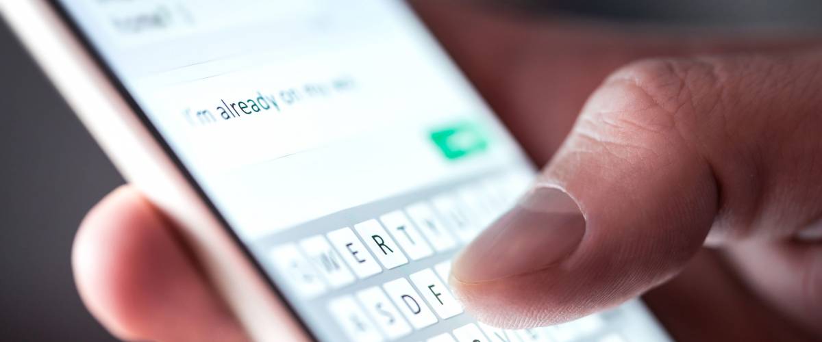 Man sending text message on a smartphone