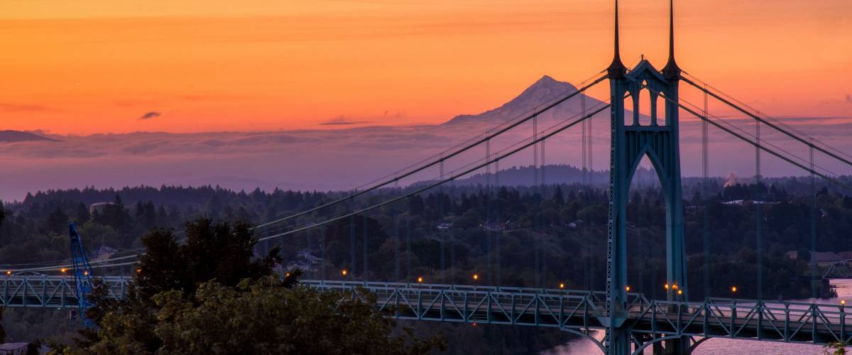 Gothic style arches tracery St Johns bridge and Mt Hood with beautiful sunrise in Portland, Oregon.