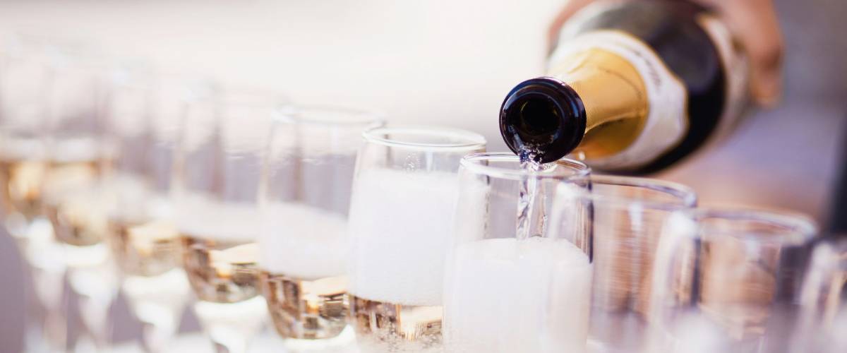 Bartender pouring champagne into glasses