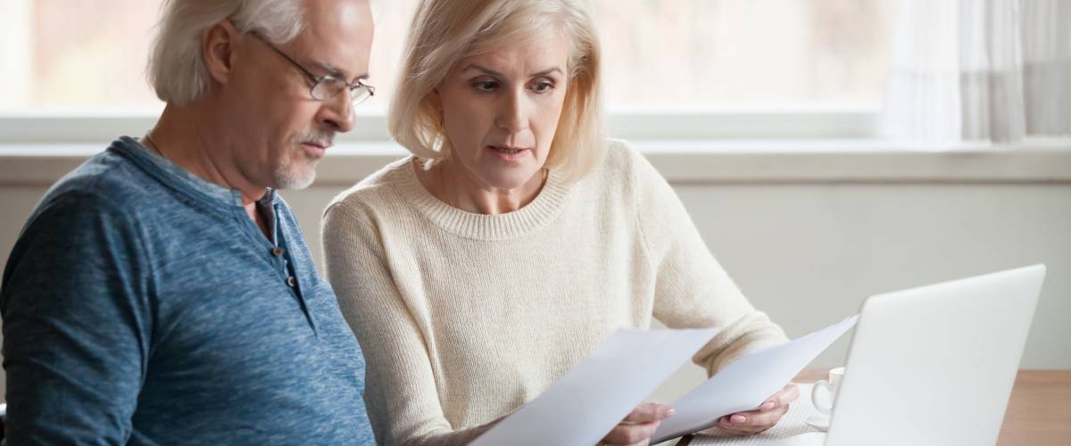 senior couple looking at bills
