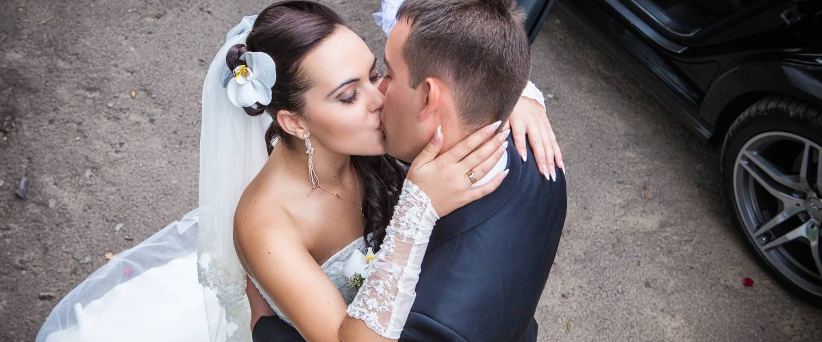 bride and groom kissing aerial view