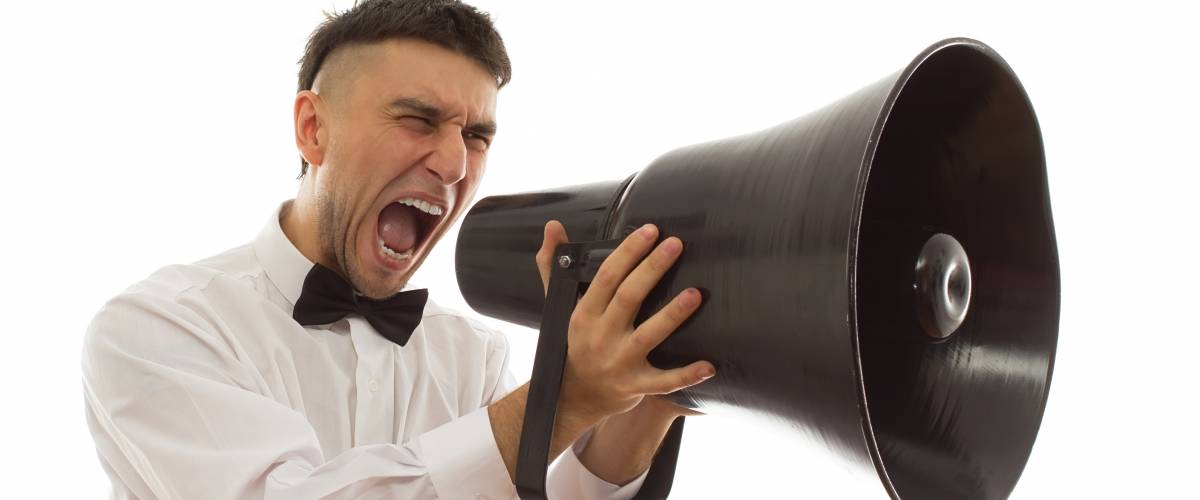 groom shouting into massive novelty megaphone