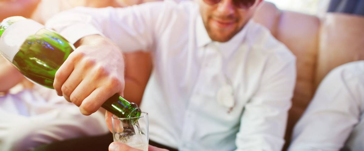 best man pouring champagne on wedding day