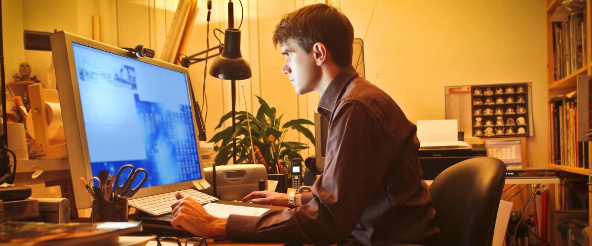 Young man working at the computer in his home office