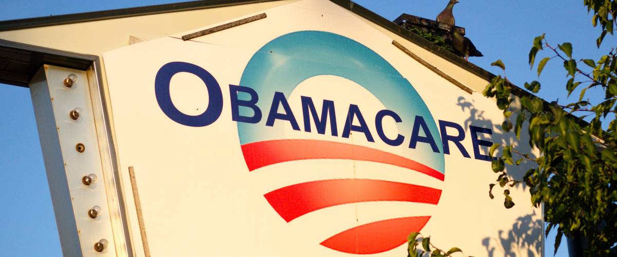 Sign outside a location offering help with Obamacare