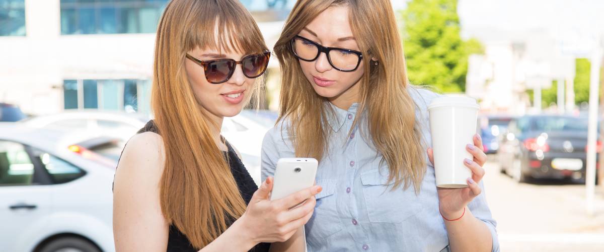 Woman receiving money from friend via her phone