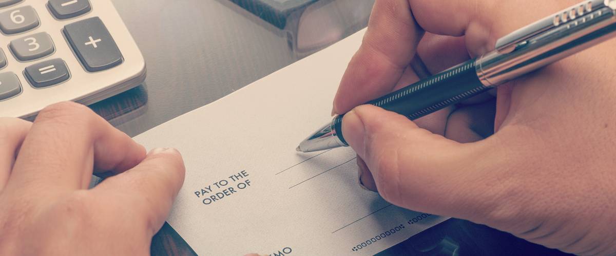 A man writing a personal check