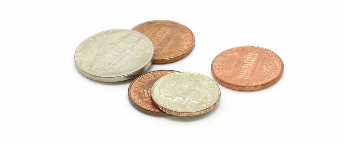 A collection of pocket change. $.18 shot on a white background. U.S. coins.