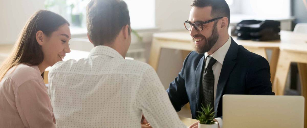 Banker in suit consulting young couple
