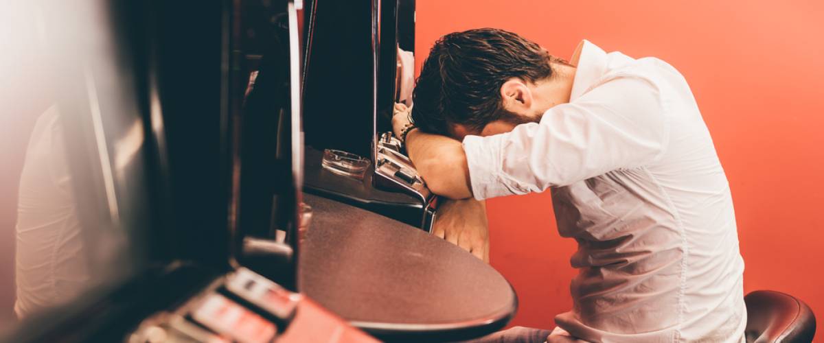 Man losing at slot machine