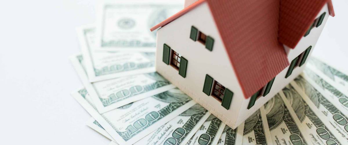 building, mortgage, investment, real estate and property concept - close up of home or house model and money
