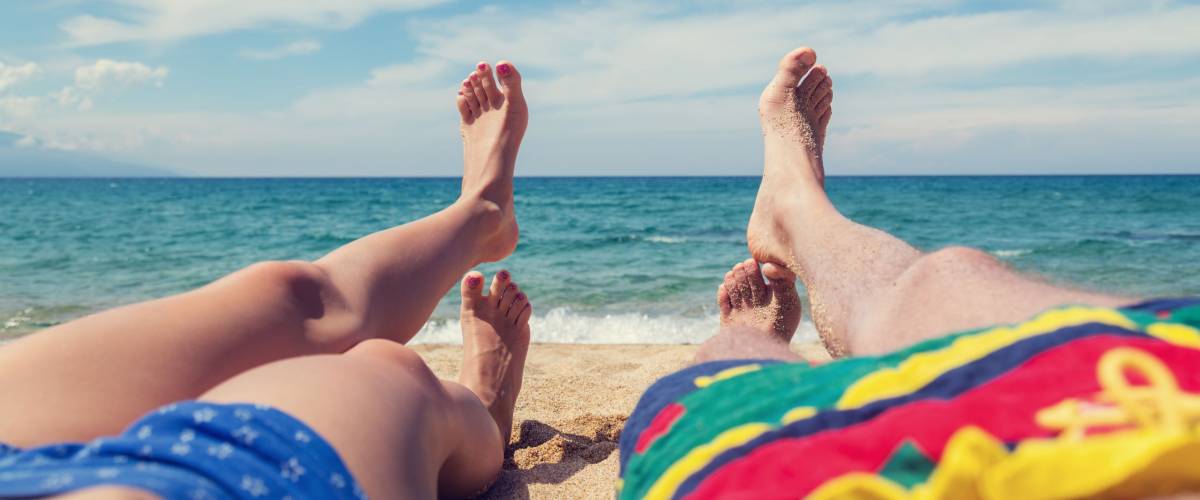 Couple enjoying on the sandy ocean / sea beach.