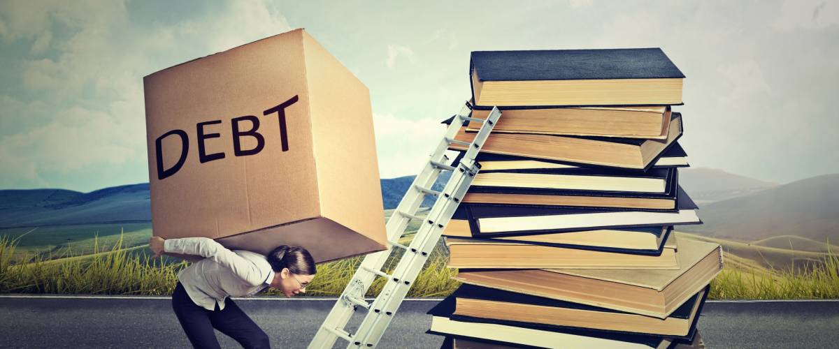Student loan debt concept. Young woman with heavy box full of debt carrying it up the education ladder