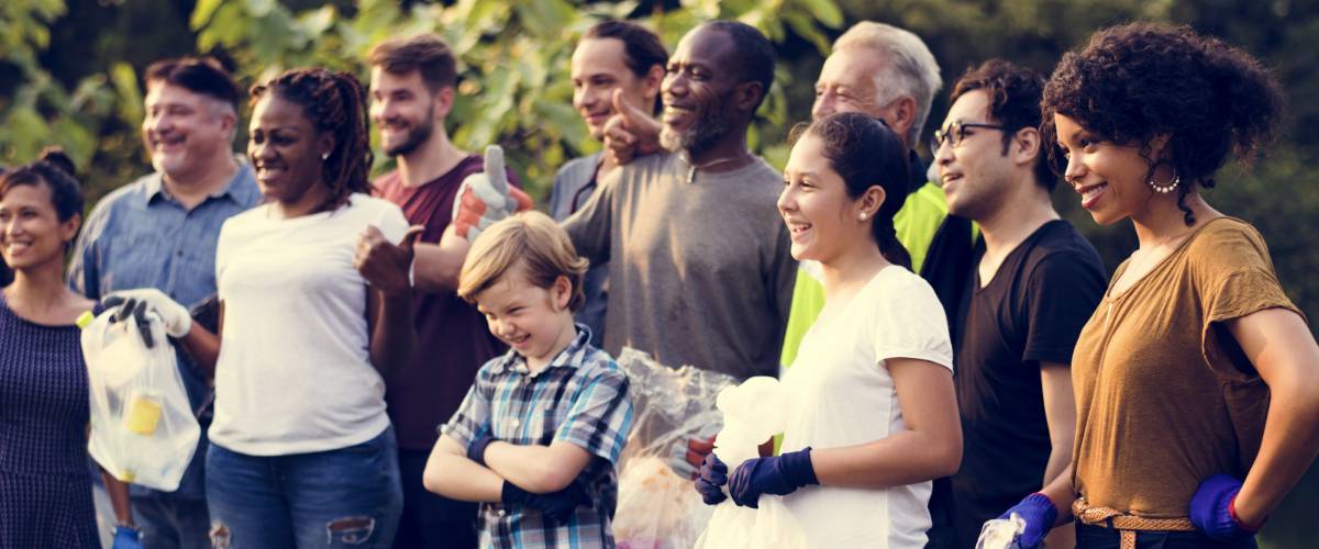 Diverse Group of People Pick Up Trash in The Park Volunteer Community Service