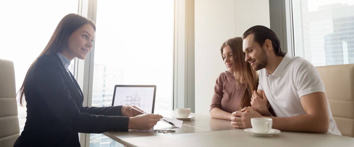 Female financial planner meeting with young couple