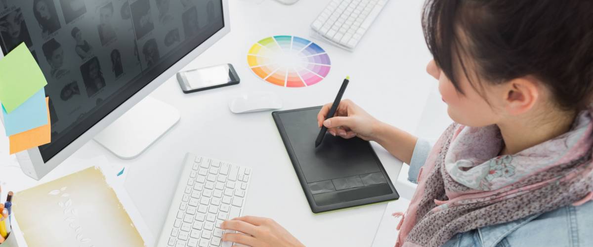 High angle view of an artist drawing something on graphic tablet at the office
