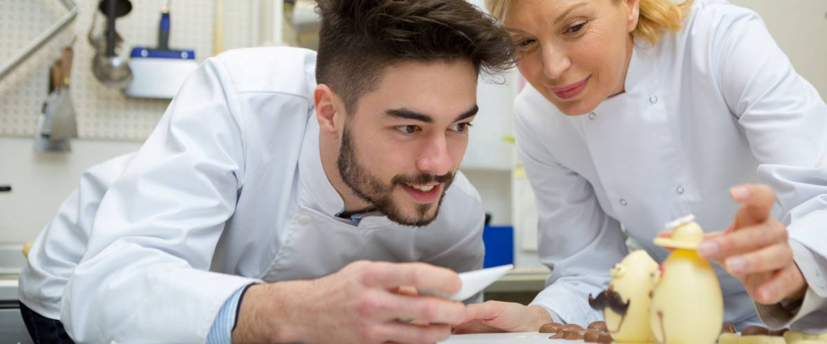 young chocolatier decorating egg chocolate