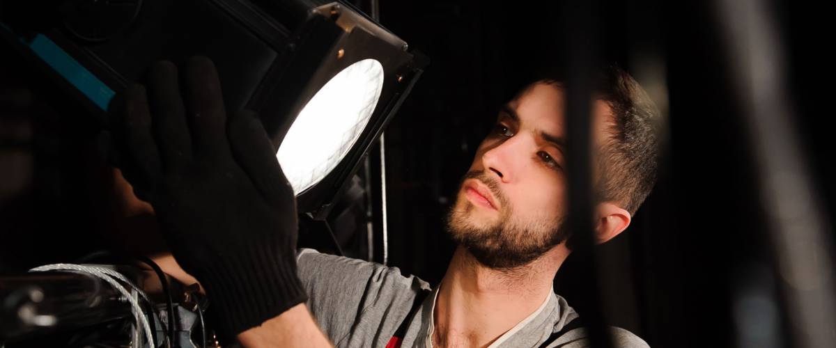 The stage worker sets up the lights