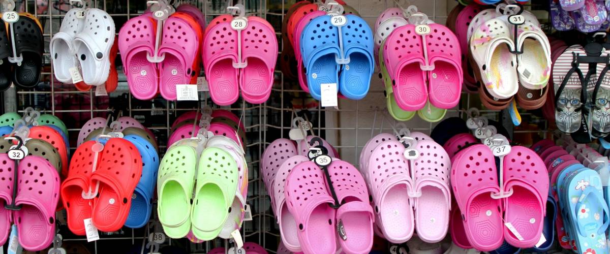 Valras-Plage, Herault, France - Aug 25 2017: Rack with lots of pairs of childrens soft rubber sandals or