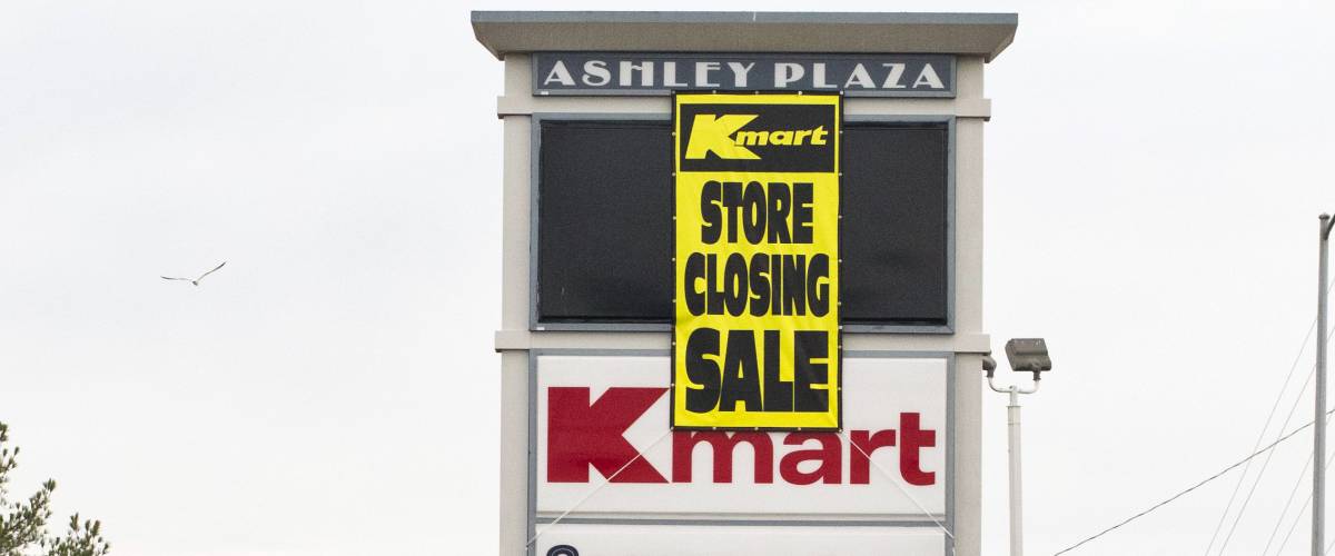 KMart store in Goldsboro, North Carolina, slated to close in March 2017. Maintenance truck in front of Ashley Plaza sign where banner advertising the KMart liquidation sale was just hung.