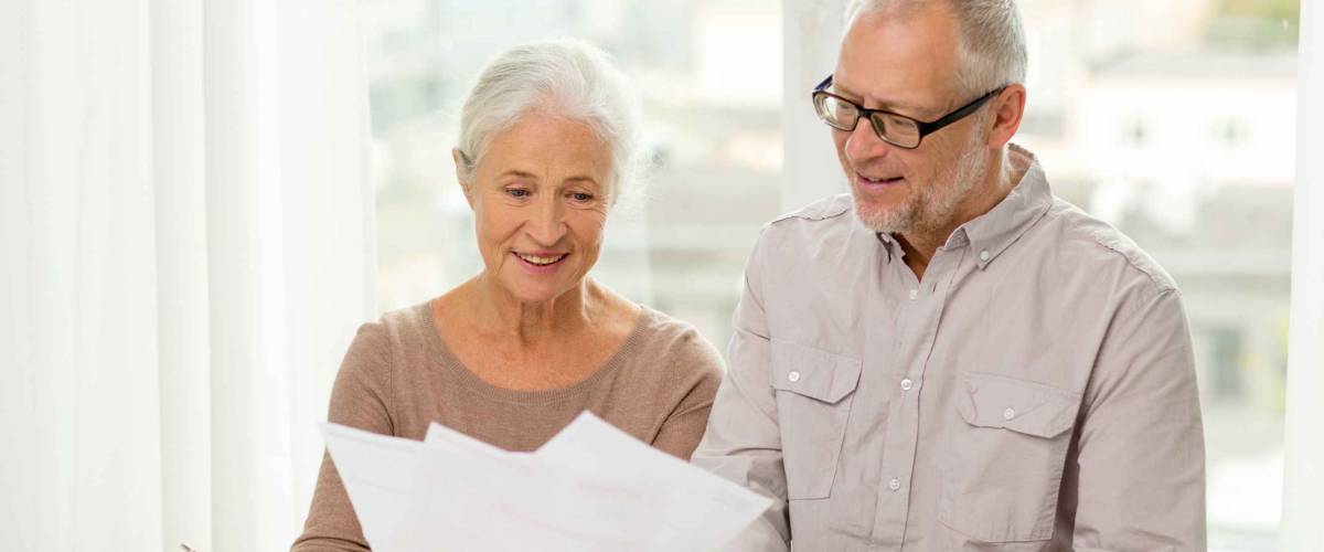 family, business, savings, age and people concept - smiling senior couple with papers and calculator at home