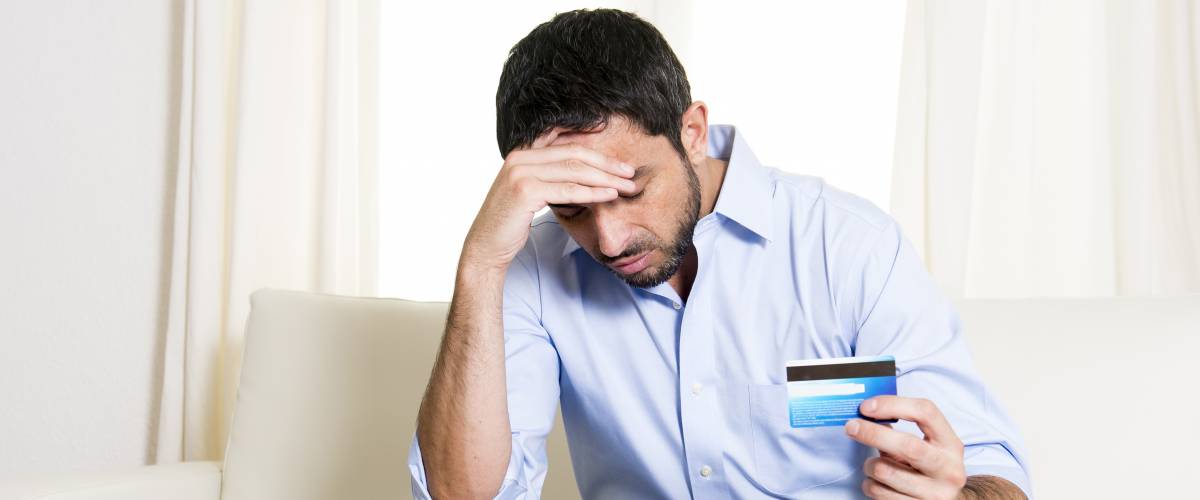 Stressed man with credit card